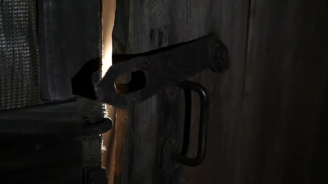 Rays of light through the slits of the door.