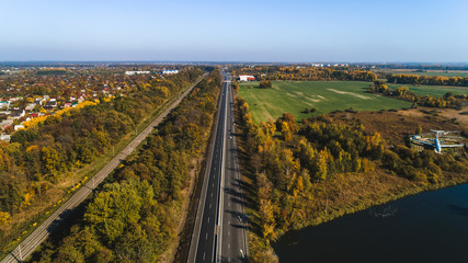 Fototapeta na wymiar Aerial view of the rural traffic near lake and airplane.