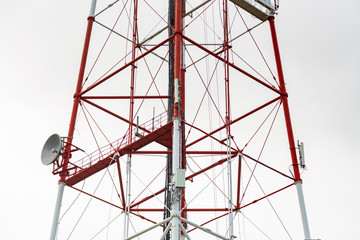 4G TV radio tower with parabolic antenna and satellite dish. Broadcast network signal. High...