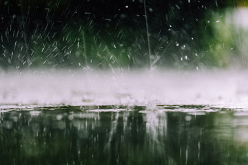 Vintage color tone of close up rain water drop splash falling to the floor in rainy season