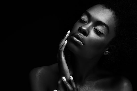 black and white photo of beautiful african american woman isolated on black