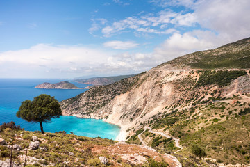 Myrthos beach on Kefalonia island at sunny day. Turquoise Ionian Sea, serpentine road and picturesque coast line. 