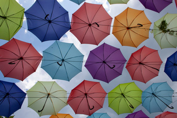 Fototapeta na wymiar colorful umbrellas under sky soft focused background
