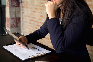 Businesswoman using tablet to the situation on the market value , Business concept.