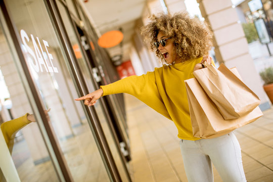 Young Black Woman With Curly Hair In Shopping