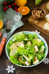Pear Salad, Walnut, Camembert Cheese and Vinaigrette Dressing on a festive Christmas table.Traditional french cuisine. Copy space.