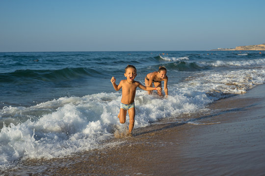 Smiling  and happy mother and her son playing the beach. Concept of friendly family. Mexico beach.