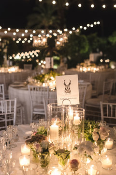 Decorated table for a wedding at night with candles