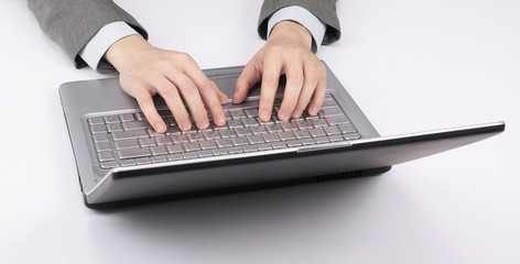 closeup.businessman typing on laptop keyboard. business concept