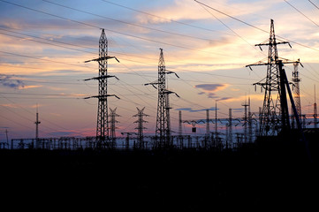 Fototapeta premium Energy. Supports high electricity against the sunset.