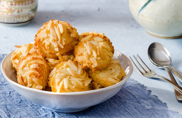 Delicious biscuits with almonds on delicate blue background
