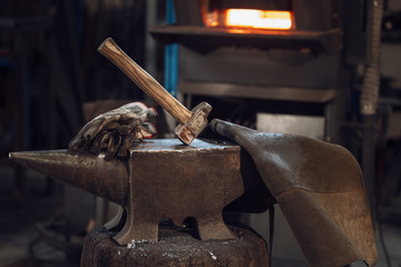 Mallet on an anvil in front of a furnace