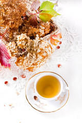 Tea in the rustic vintage Chic style. Garden tea Party. Teapot of dry flowers. Cup of tea with autumn decor on table, with hydrangea and pumpkin