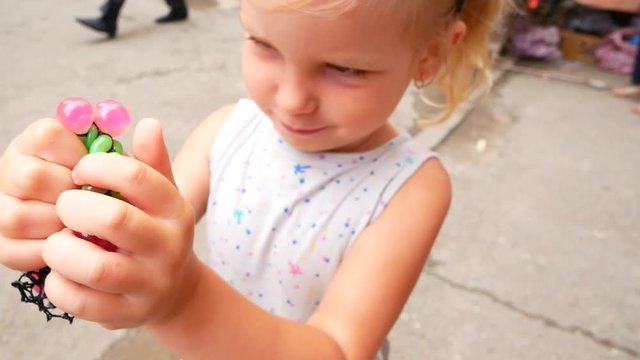 girl with colored transformer ball. child plays with transformer ball