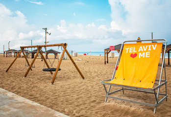 Panoramic view of the beach at Tel-Aviv with large lounge chairs