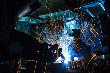 worker with protective mask welding metal