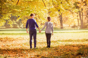 Fototapeta premium Young couple walking in park