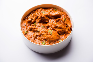 Murgh Makhani / Butter chicken tikka masala served with roti / Paratha and plain rice along with onion salad. selective focus