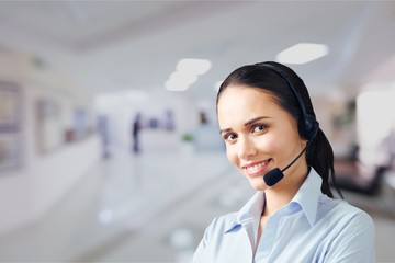 Young female phone service manager on blurred office background