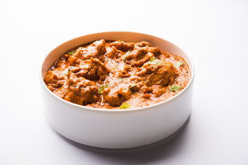 Murgh Makhani / Butter chicken tikka masala served with roti / Paratha and plain rice along with onion salad. selective focus