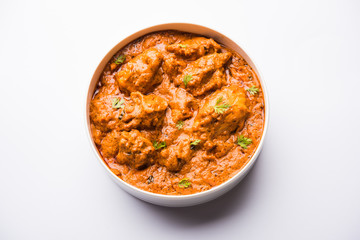 Murgh Makhani / Butter chicken tikka masala served with roti / Paratha and plain rice along with onion salad. selective focus
