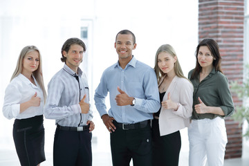 successful multinational business team showing thumb up