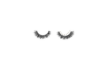 Dramatic black long false eyelashes decorated with bright sparkling golden glitter isolated on white background shot with studio light