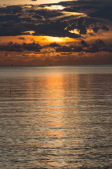 Black rain is blocking sunrise in the sea.