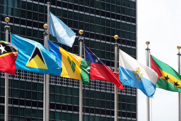 set of coloured flags of many nations of the world that waving all along