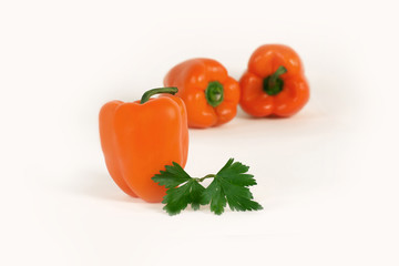 bell pepper and sprig of parsley .isolated on a white background