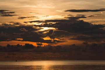 Black rain is blocking sunrise in the sea.