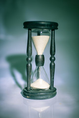hourglass on dark background.the concept of time