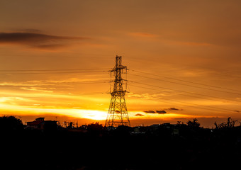 Fototapeta premium High voltage pylons on the evening sunset, silhouette