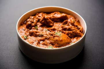 Murgh Makhani / Butter chicken tikka masala served with roti / Paratha and plain rice along with onion salad. selective focus