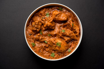 Murgh Makhani / Butter chicken tikka masala served with roti / Paratha and plain rice along with onion salad. selective focus