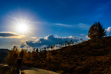 Beautiful autumn landscape with the suns rays from Sirnea Village in Brasov Romania