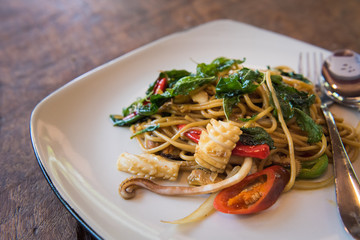 Spaghetti with Spicy Mixed Seafood on wooden table