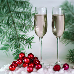 two glasses with champagne, and boxes with gifts on Christmas b