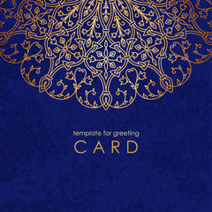 Template greeting card. Round gold mandala on blue background with texture and inscription.