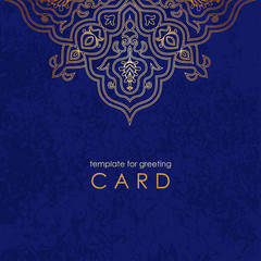 Template greeting card. Round gold mandala on blue background with texture and inscription.