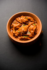 Murgh Makhani / Butter chicken tikka masala served with roti / Paratha and plain rice along with onion salad. selective focus