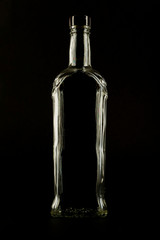 Silhouette of a bottle of alcohol on a black background - obrazy, fototapety, plakaty