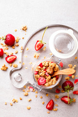 Granola Cereal bar with Strawberries on the Gray Background in a glass jar. Muesli Breakfast. Healthy Food sweet dessert snack. Diet Nutrition Concept. Top View. Vegetarian food.Flat Lay.Copy space