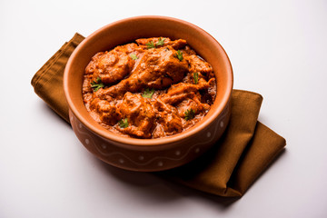 Murgh Makhani / Butter chicken tikka masala served with roti / Paratha and plain rice along with onion salad. selective focus