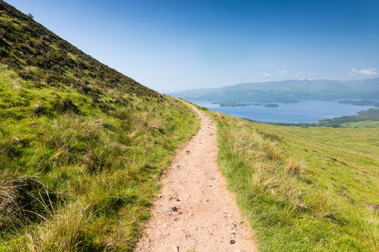 a path up a hill and Loch Lomond
