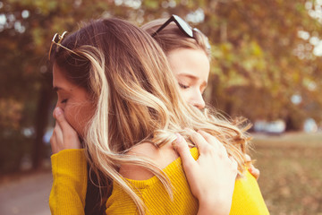 two girl friends hug each other friendship comfort  support concept