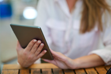 Close-up of woman using tablet. Businesswoman outdoor concept.