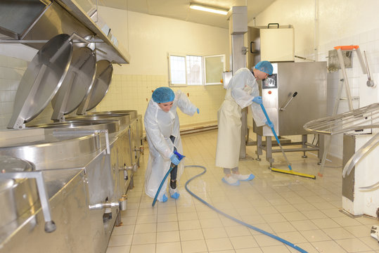 cleaners cleaning industrial kitchen floor