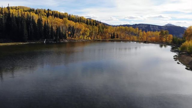 Autumn leaves over beautiful mountain lake