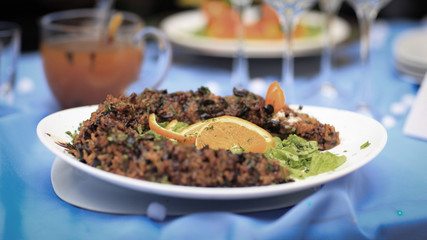 rice pilaf with meat and vegetables on the holiday table